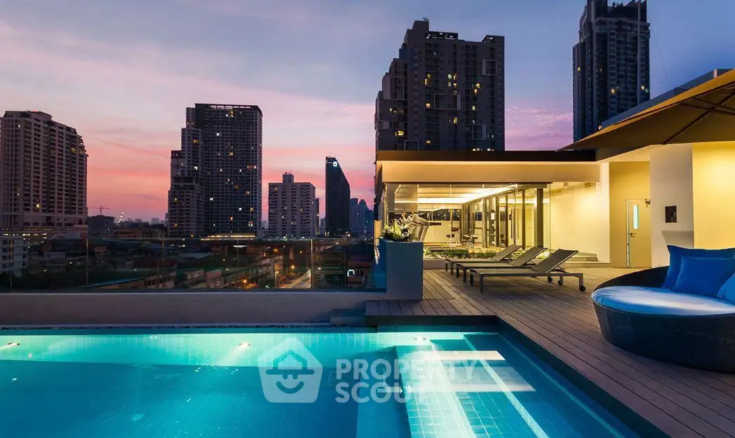 Luxurious rooftop pool with stunning city skyline views at sunset, perfect for urban living.