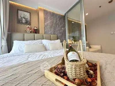Luxurious bedroom with elegant decor and wine basket, perfect for relaxation.