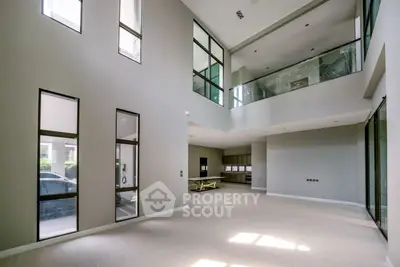 Spacious modern living room with high ceilings and large windows