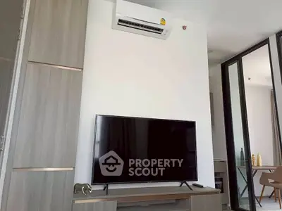 Modern living room with sleek TV setup and air conditioning