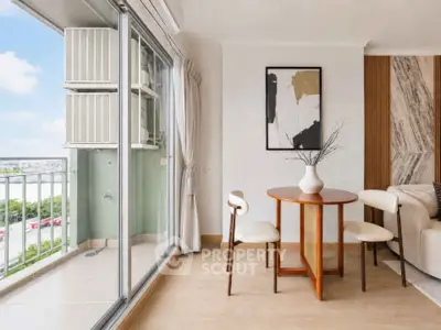 Modern living room with stylish decor and balcony view, featuring elegant furniture and natural light.