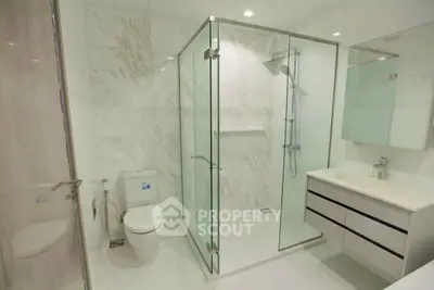 Modern bathroom with glass shower and sleek fixtures