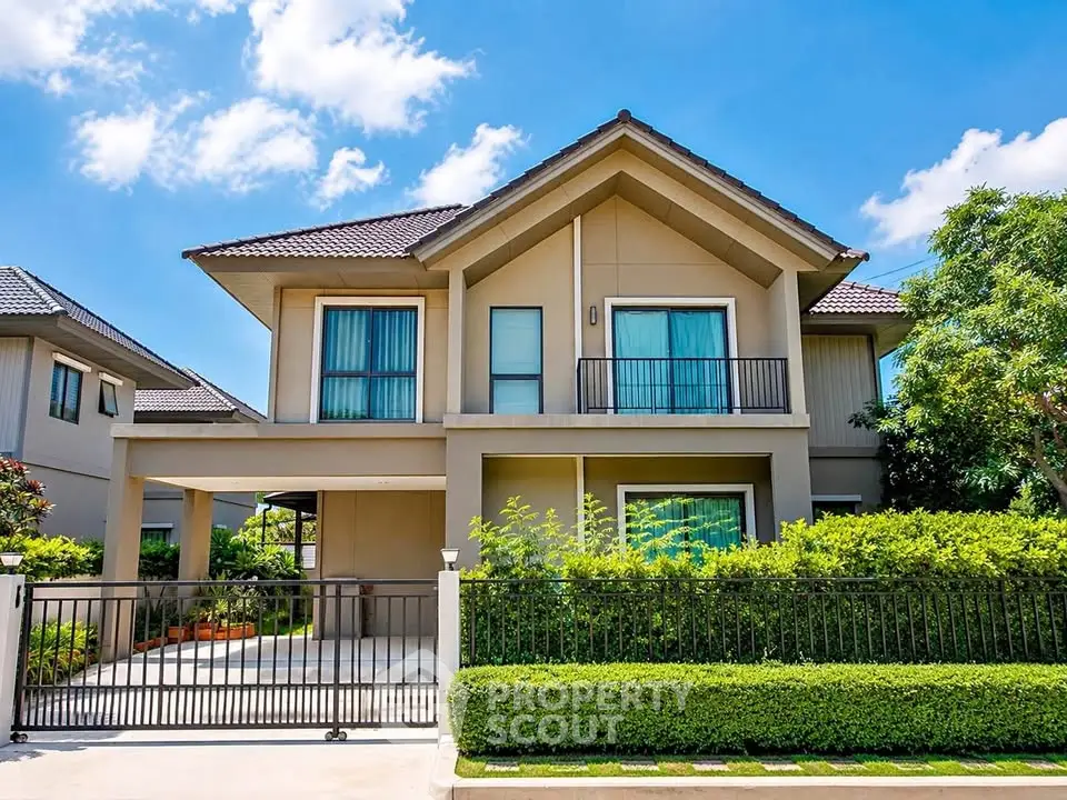 Stunning modern two-story house with lush greenery and gated entrance, perfect for family living.