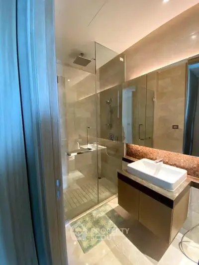 Luxurious modern bathroom with glass shower and elegant vanity