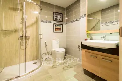 Modern bathroom with glass shower and stylish tiles in a contemporary home.