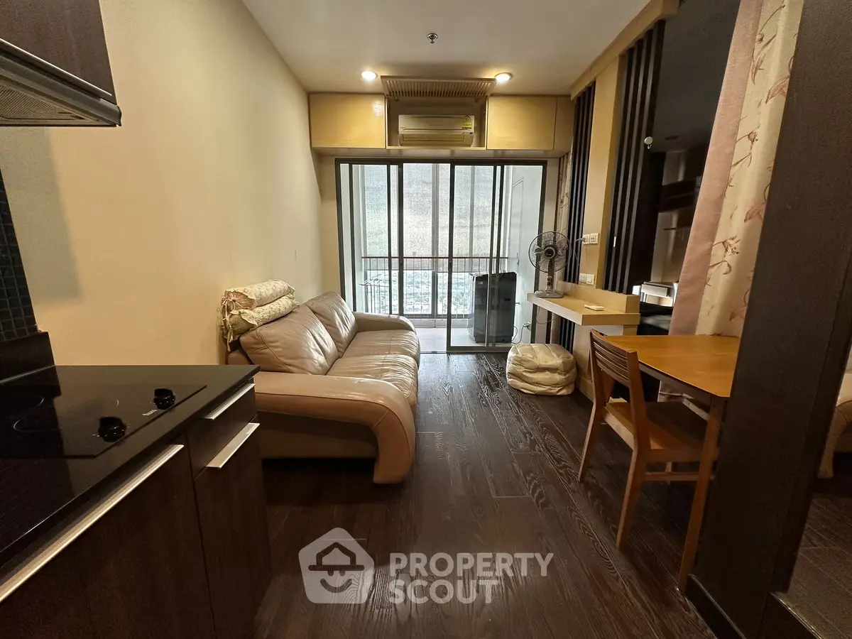 Cozy living room with modern furnishings and balcony view