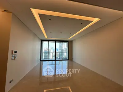 Spacious modern living room with city view and elegant ceiling lighting