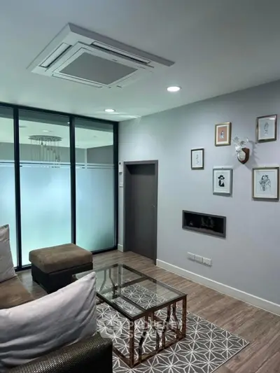 Modern living room with stylish decor and glass partition