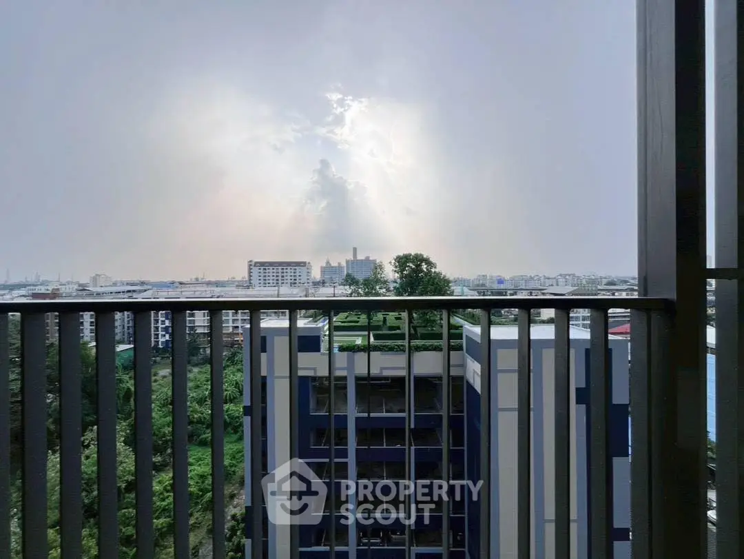 Stunning cityscape view from a modern balcony with lush greenery and skyline.