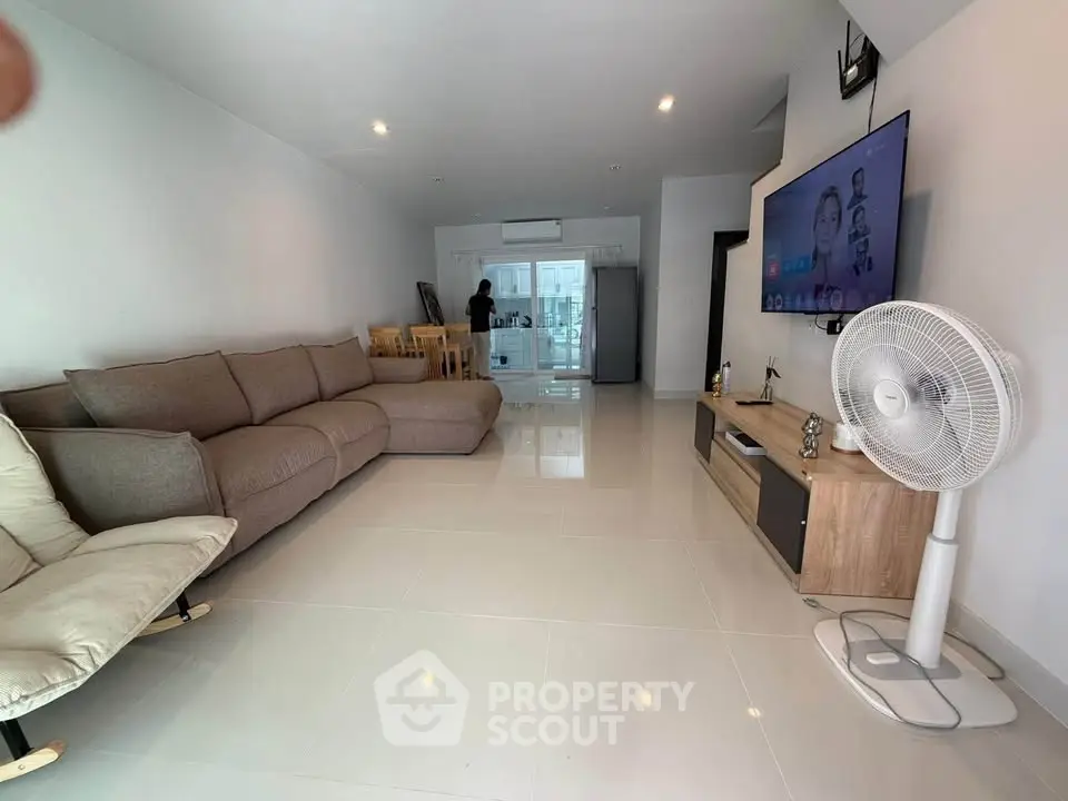 Spacious modern living room with sleek furniture and open layout, perfect for relaxation and entertainment.