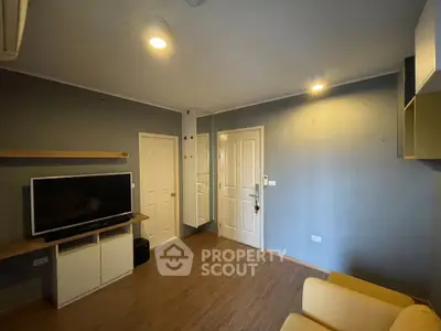 Modern living room with sleek TV setup and cozy seating area