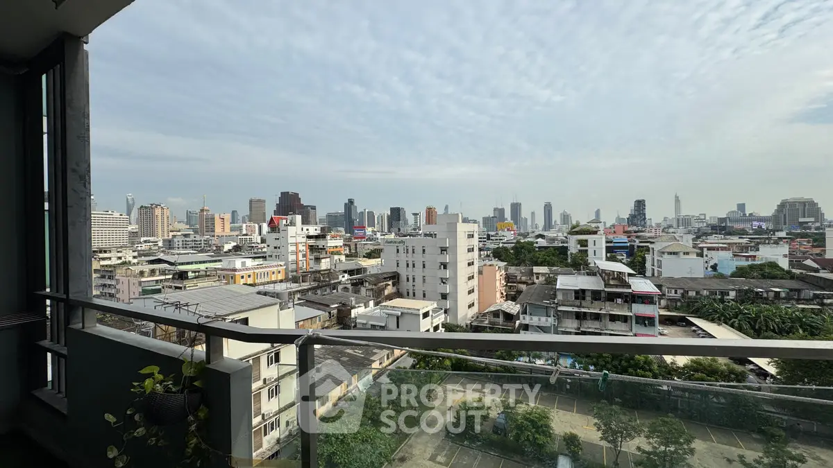 Stunning cityscape view from a high-rise balcony overlooking urban skyline.