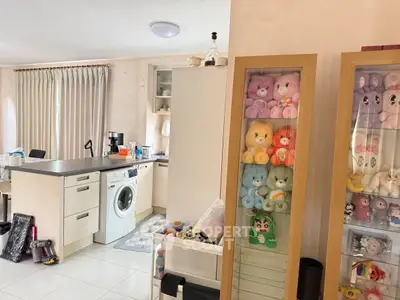 Cozy kitchen with washing machine and plush toy display cabinet