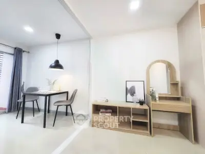 Modern open-plan living and dining area with stylish furniture and elegant decor.