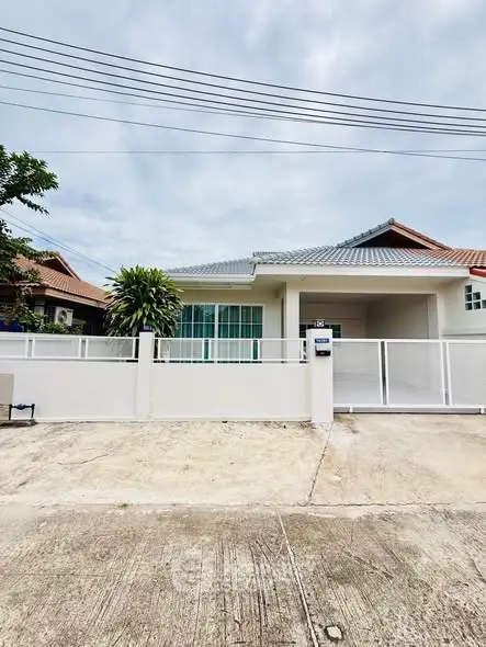 Charming single-story house with modern design and spacious driveway in a serene neighborhood.
