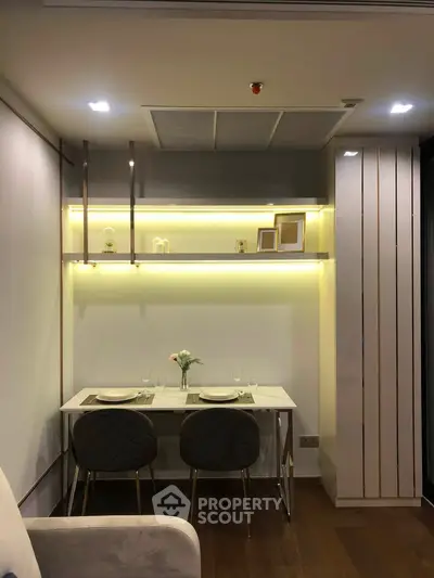 Modern dining area with elegant lighting and stylish decor in a contemporary apartment.
