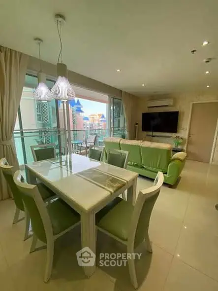 Spacious living room with modern dining area and balcony view