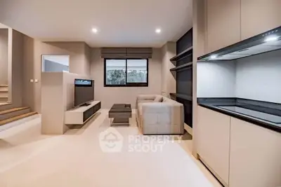 Modern living room with sleek design and open kitchen layout