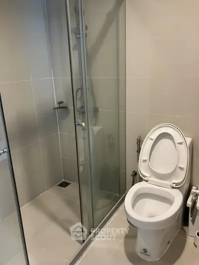 Modern bathroom with glass shower and sleek toilet design