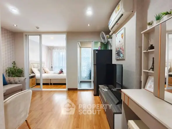 Modern apartment interior with cozy living room and stylish bedroom, featuring wooden flooring and contemporary decor.