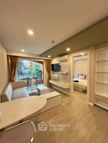 Modern open-plan living room with balcony and stylish decor