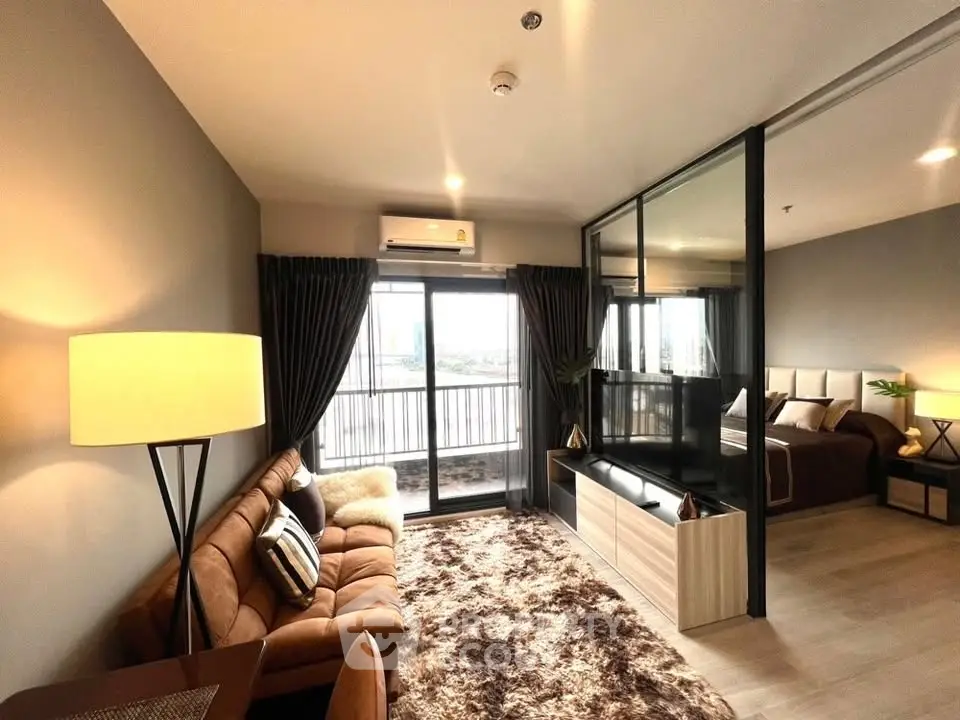 Modern living room with cozy sofa, stylish decor, and large windows offering city views in a chic apartment.