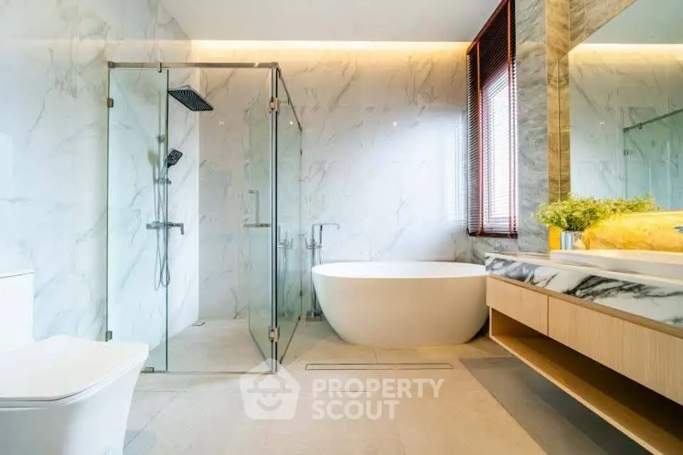 Luxurious modern bathroom with marble walls and freestanding bathtub