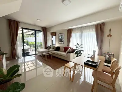 Spacious living room with modern decor and large windows for natural light