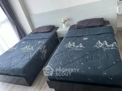 Modern bedroom with twin beds and stylish decor, perfect for cozy living.