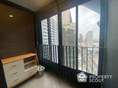 Modern high-rise balcony with stunning city view and sleek interior design.