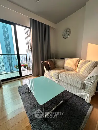 Chic living room with cozy sofa and stunning city view from balcony