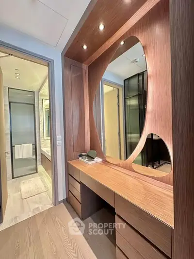 Elegant modern bathroom with unique wooden vanity and stylish mirror design.