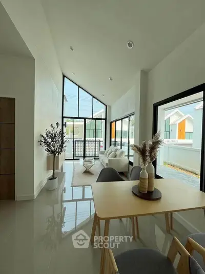 Modern living room with high ceilings and large windows in a stylish home