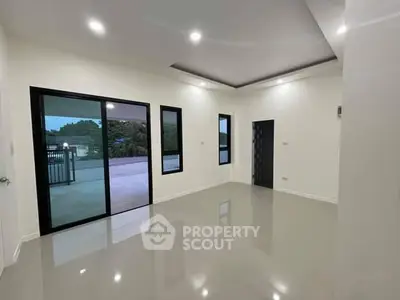 Spacious modern living room with large windows and sleek flooring