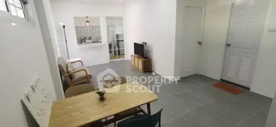 Spacious living room with modern decor and open kitchen view