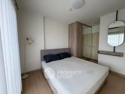 Modern bedroom with minimalist design and ample natural light