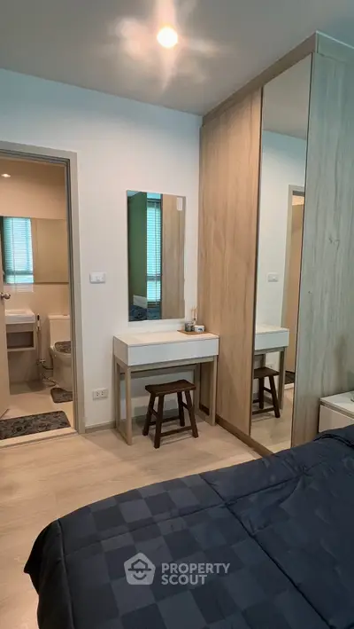 Modern bedroom with ensuite bathroom and stylish wooden furniture