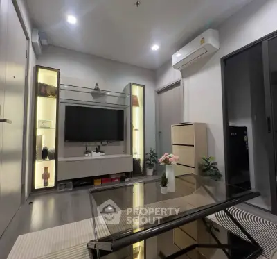 Modern living room with sleek furniture and built-in TV unit, featuring ambient lighting and air conditioning.
