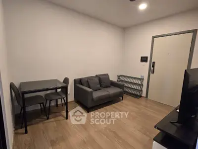 Modern living room with sleek furniture and wooden flooring, perfect for cozy urban living.