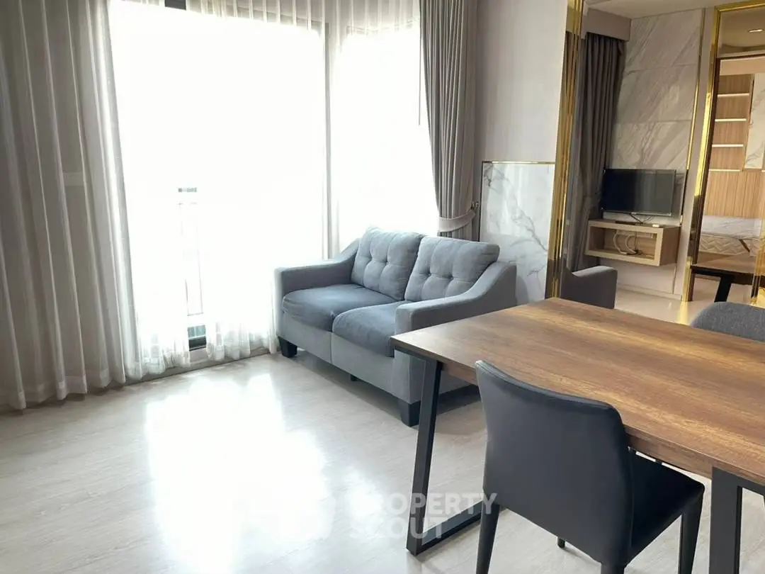 Modern living room with stylish furniture and natural light in a contemporary apartment.