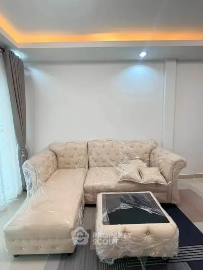 Luxurious living room with elegant beige sofa and modern lighting, perfect for stylish relaxation.