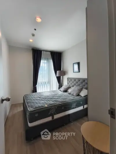 Modern bedroom with stylish decor and natural light in a contemporary apartment.