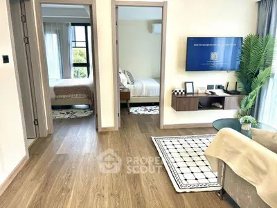 Modern apartment interior with wooden flooring, cozy living area, and two bedrooms.