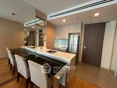 Modern kitchen with sleek design, featuring stainless steel appliances and elegant dining area.