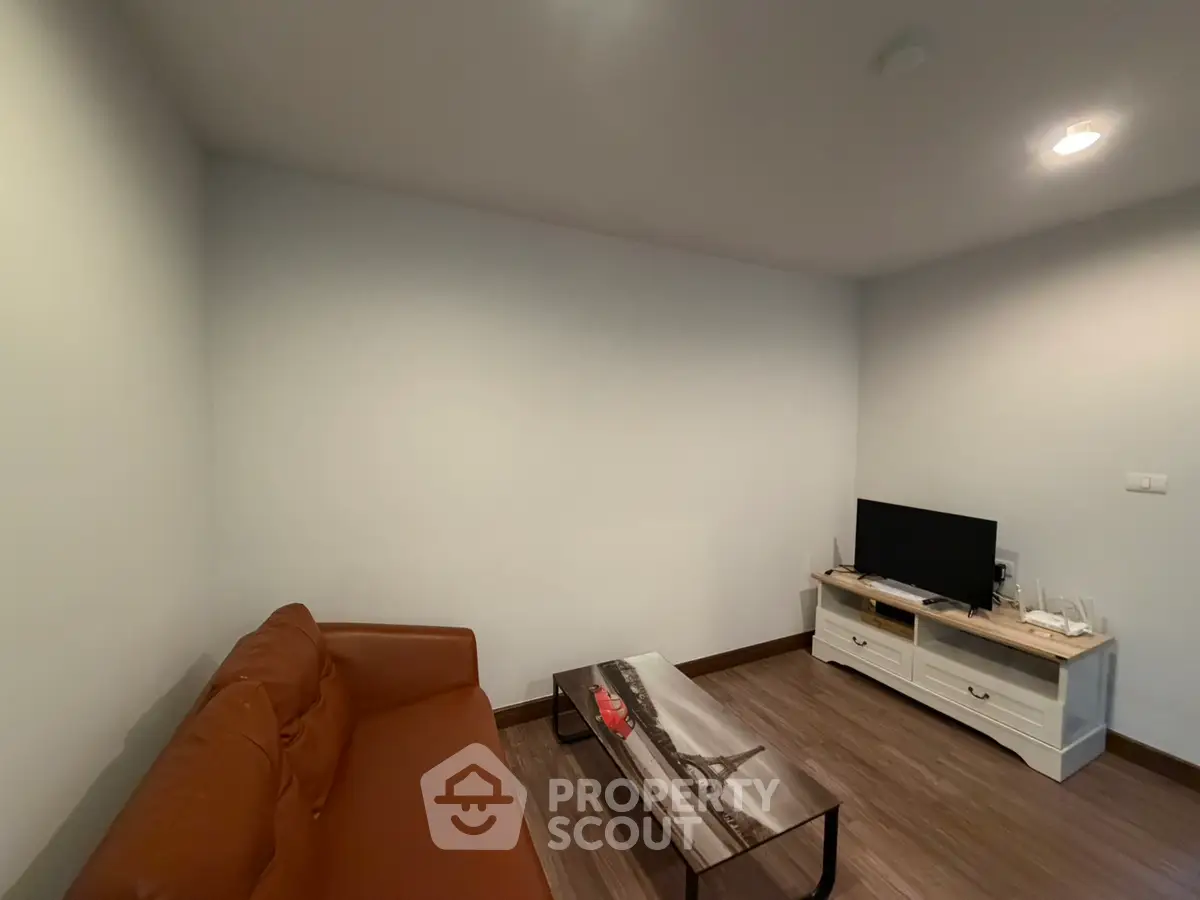 Cozy living room with brown sofa and modern TV setup