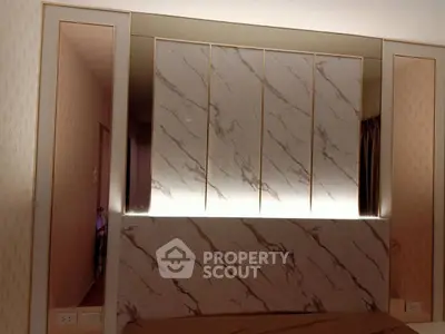 Luxurious bedroom with elegant marble wall panels and ambient lighting