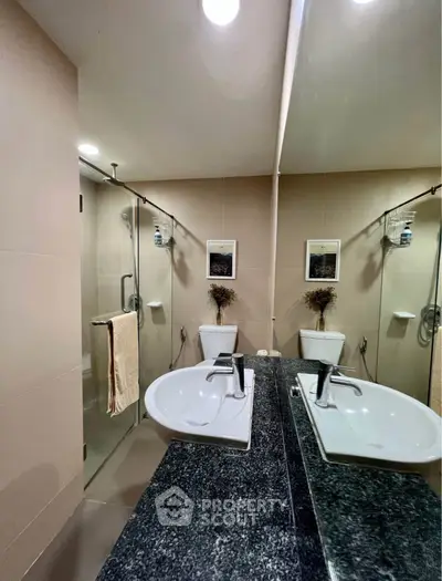 Modern bathroom with sleek fixtures and glass shower enclosure