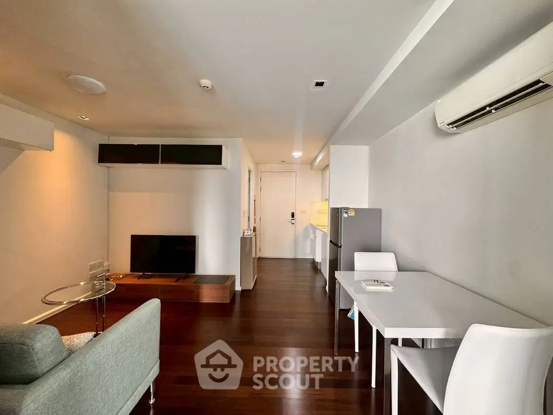Modern living room with sleek furniture and air conditioning in a stylish apartment.