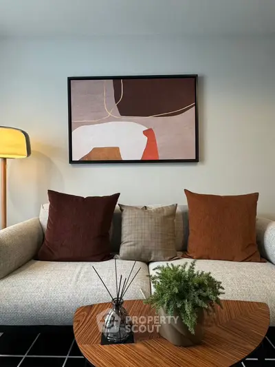 Stylish living room with modern decor, abstract art, and cozy seating for ultimate comfort.