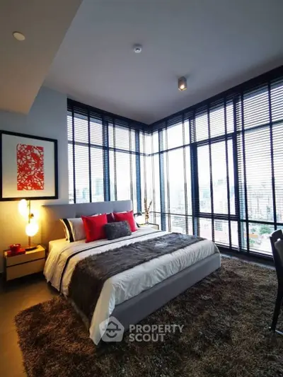 Luxurious bedroom with panoramic city views and modern decor